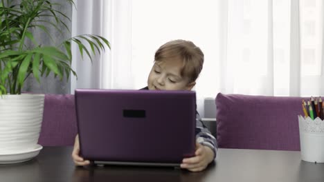 Girl-doing-lessons-at-home-using-digital-laptop-computer.-Distance-education