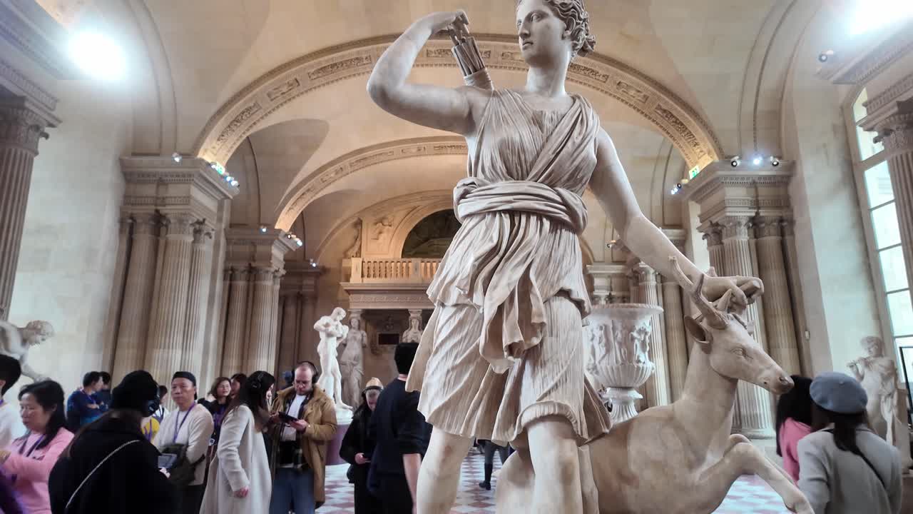 Diana of Versailles with a deer. Artemis goddess of the hunt, nature, wildlife with a doe, quiver and arrows. Caryatid room in the Louvre museum.