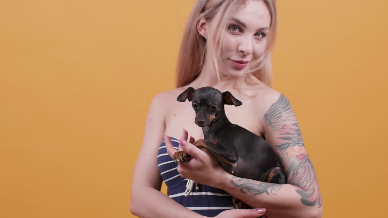 A woman holding her pet dog