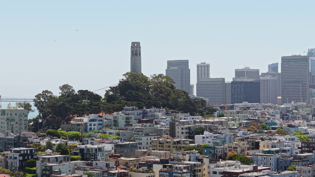 San Francisco USA, Drone Shot of Coit Tower Landmark on Telegraph Hill With Downtown Skyscrapers in Misty Background