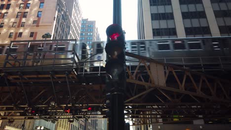 close up chicago l passing downtown city loop buildings and stoplight