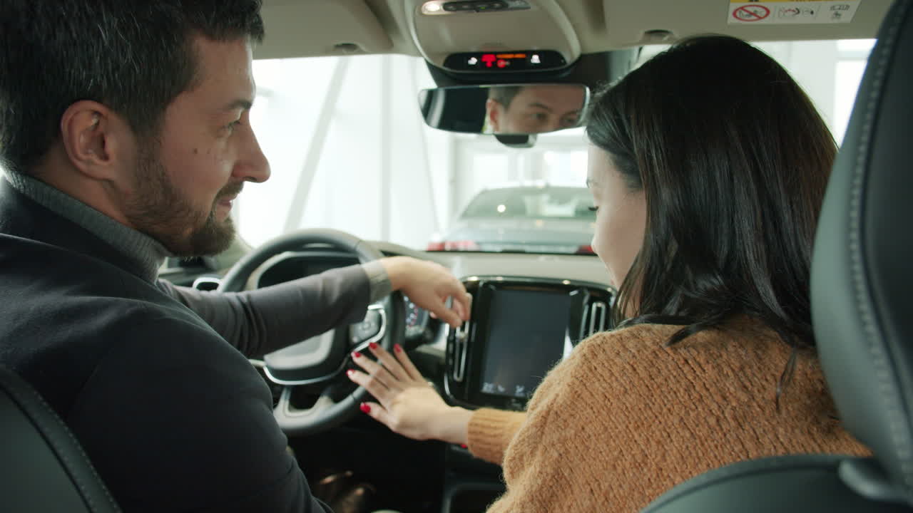 Customer and Salesperson in Car Showroom