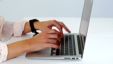 Woman using laptop on table against white background 4k