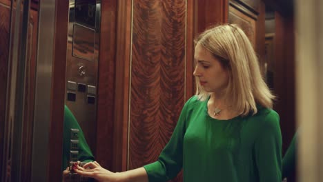 Reflection-waiting-woman-in-opening-mirror-elevator-door