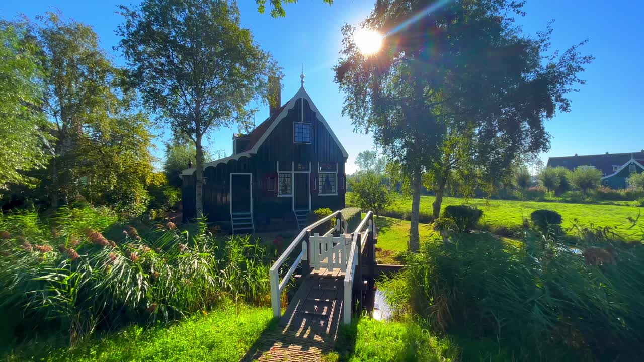 morning landscape at sunrise with traditional wooden Dutch houses and water canal, Zaanse Schans, Netherlands, Europe