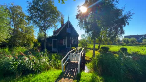 morning-landscape-at-sunrise-with-traditional-wooden-Dutch-houses-and-water-canal,-Zaanse-Schans,-Netherlands,-Europe