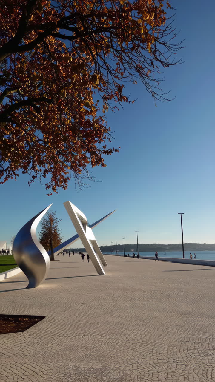 Modern Sculpture by the River in Autumn