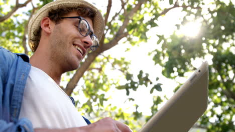 low angle view of hipster is using a tablet