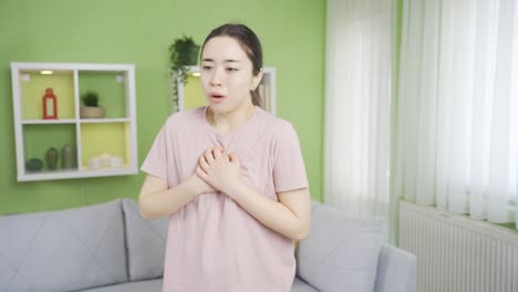 close-up asian young woman with copd unable to breathe and hurts due to chest pain and tightness.