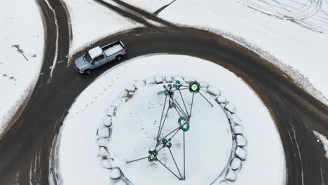 blue truck entering the traffic circle