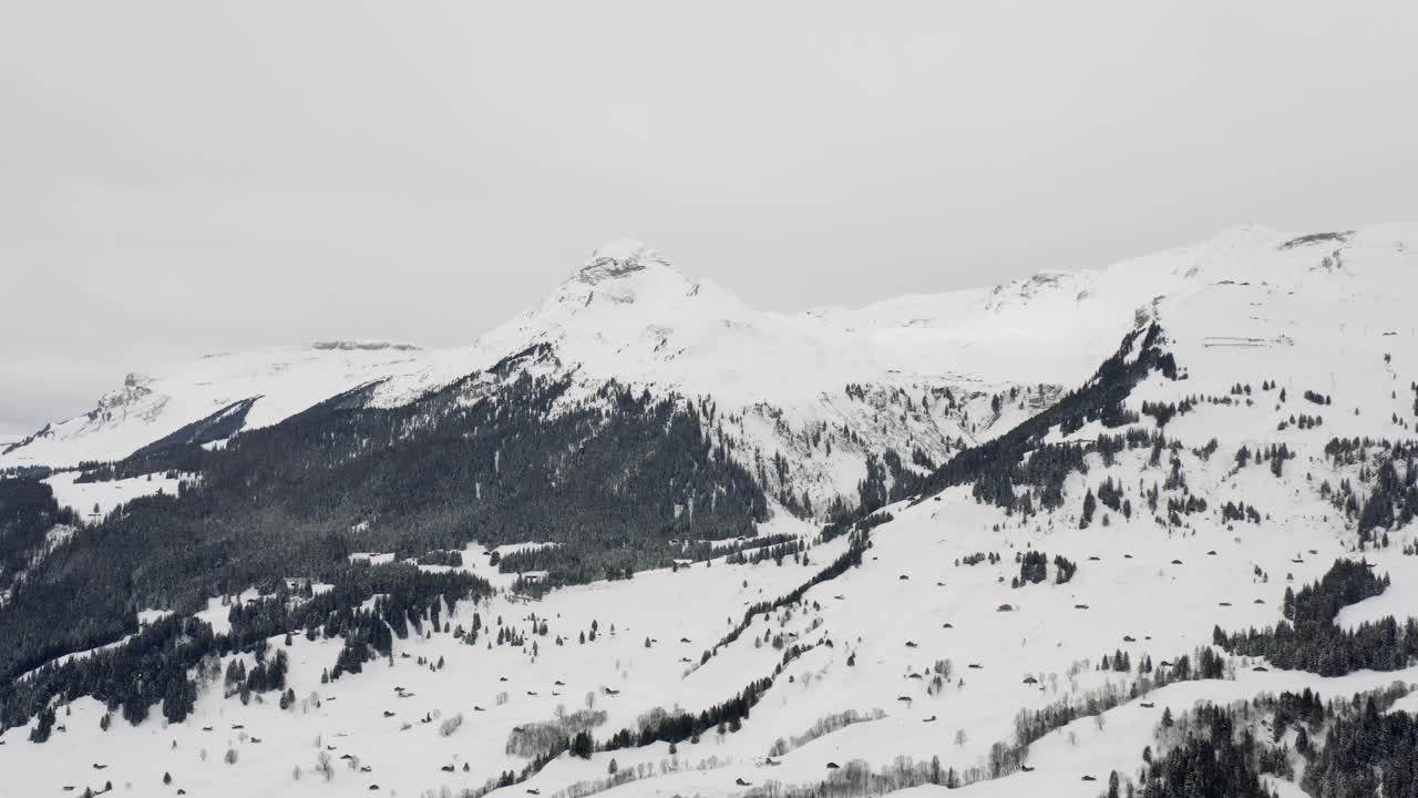 Drone Aerial view of the snowy Grindelwald and the Eiger in the beautiful swiss mountain landscape