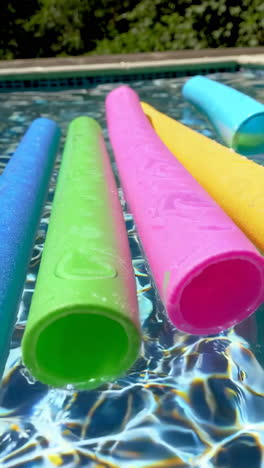 colorful pool toys floating in a swimming pool