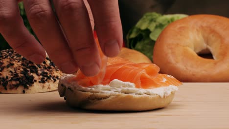 bagel sandwich brunch, lunch plate of a bagel with smoked salmon and cream cheese and ham, close up morning cafe menu.