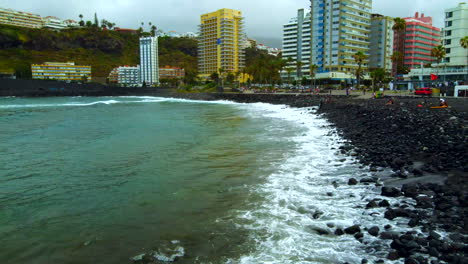 Aerial-video-of-the-waves-crashing-onto-the-black-rock-beach