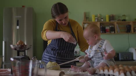 happy caucasian mother and son baking together in kitchen