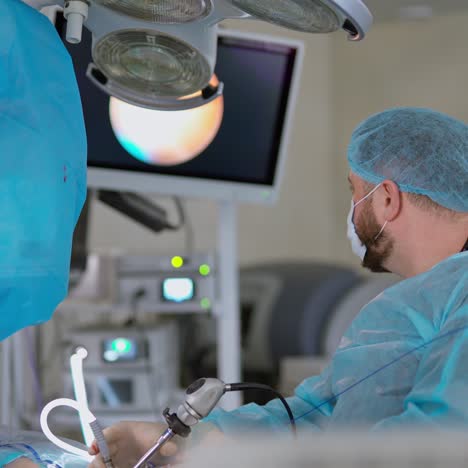 operating theatre. surgeon uses modern medical appliance during operation on kidneys. doctor is looking on the screen at surgical procedure in clinic.