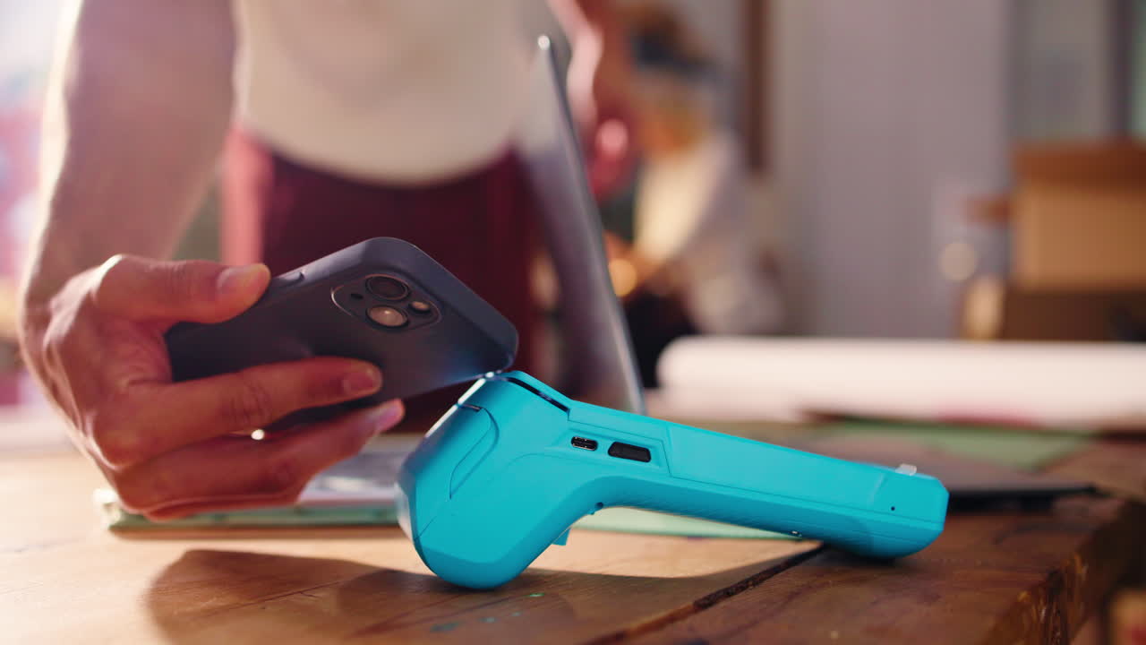 Smartphone Making Contactless Payment on Modern POS Terminal
