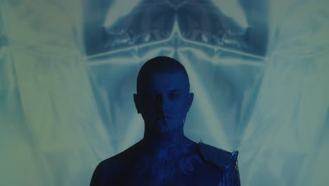gothic man in studio with light projection