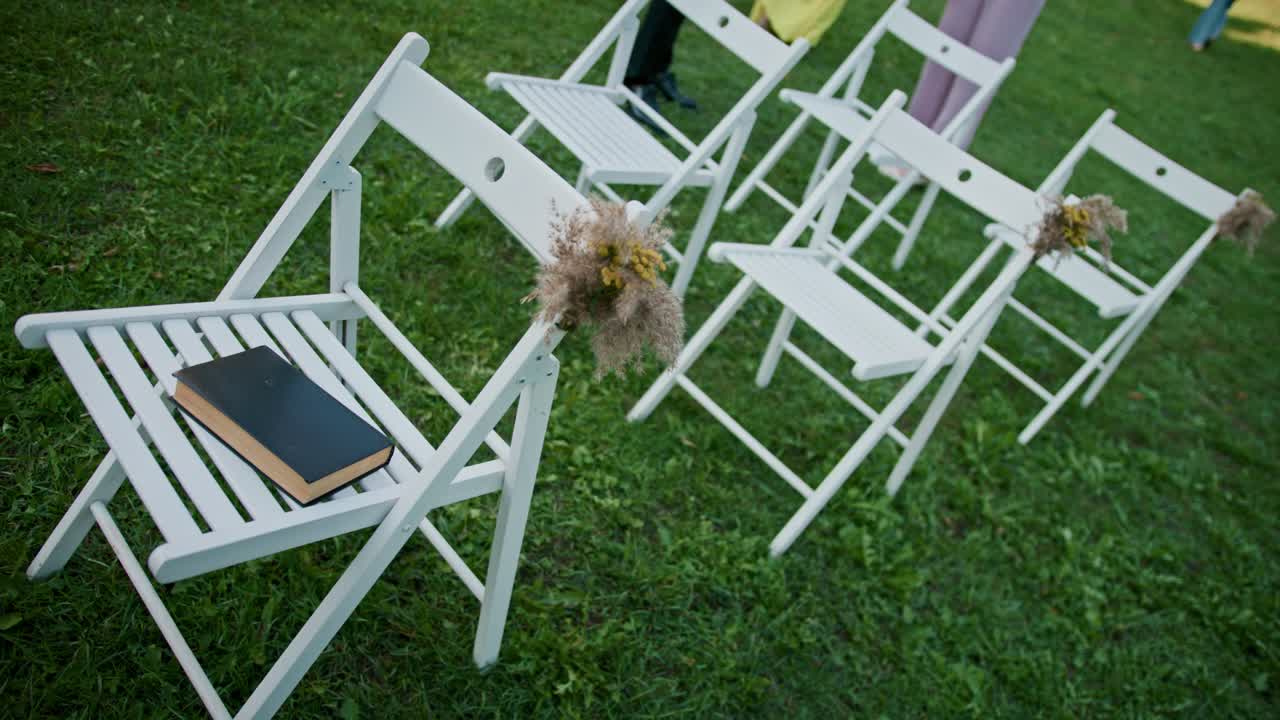 Wedding chairs with a book on the seat