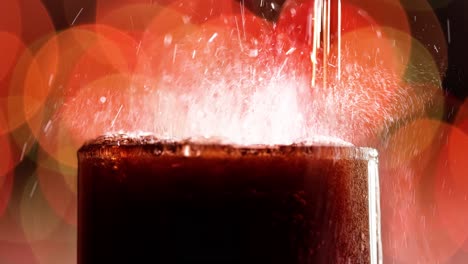 glass of cola. ice cola with splashing bubbles slow motion on a blurry light ,blurry background.