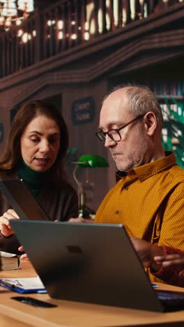 vertical video adult people studying together in a campus library and transcribing lessons
