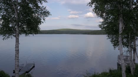 Calm-serene-and-shimmering-lake-with-boats-and-trees