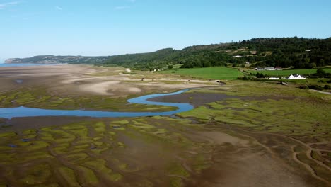 aerial view traeth coch pentraeth welsh rural marshland scenic farming countryside at sunset panning right