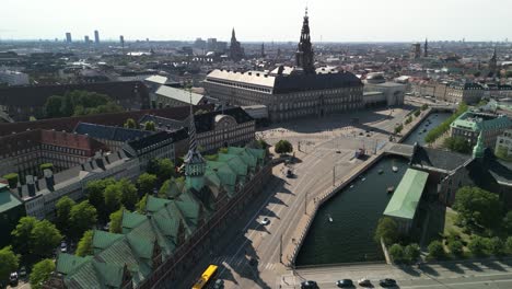 christiansborg castle and borsen stock exchange aerial pan, copenhagen, denmark