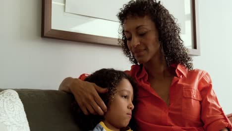 front view of african american mother consoling her son in the lobby at hospital 4k