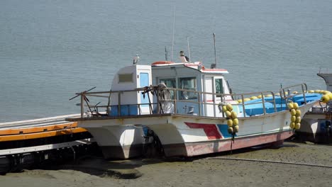 fishing boat on moored on the shoreline of ganghwado island in south korea