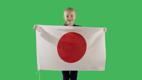 cute teenager girl holding  a japanese flag on chroma key green screen.