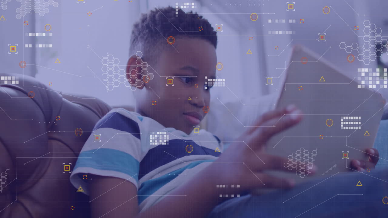 Young boy using tablet with digital data processing animation overlay