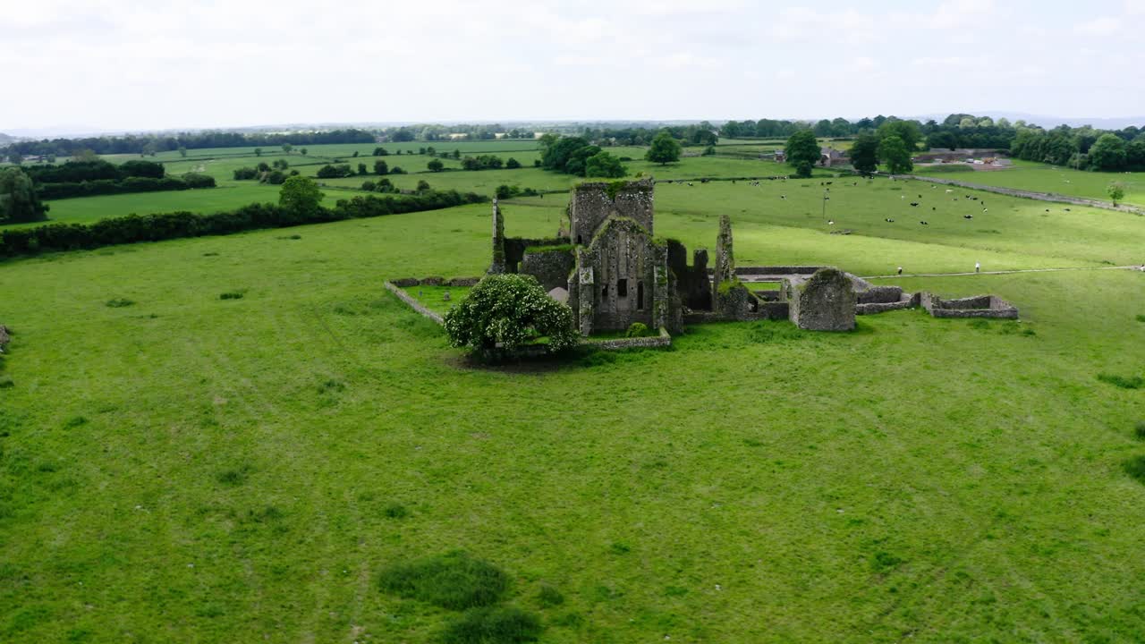 Orbiting drone shot of an abandoned castle in Ireland's countryside.