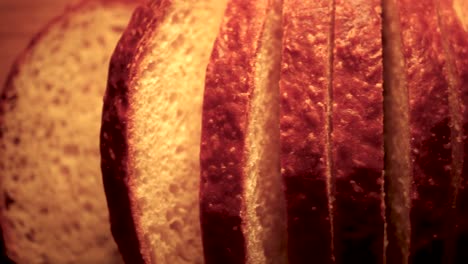 Fresh,-homemade-sliced-bread-on-cutting-board,-Close-Up-Pan