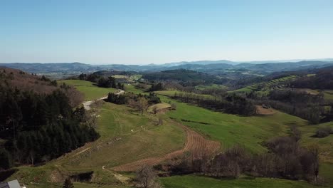 Orbital-Drone-View-Of-French-Countryside-With-Forest-And-Hills-In-Ardèche