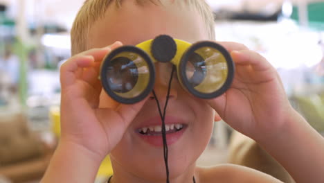 child looking through the binoculars