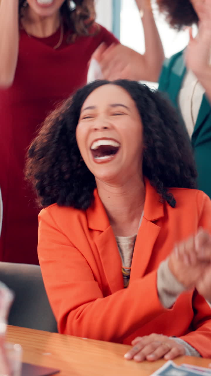 Happy Businesswomen Laughing and Clapping in an Office Meeting