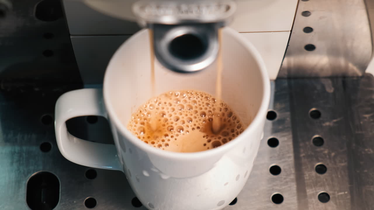 Coffee machine pouring coffee with into a cup