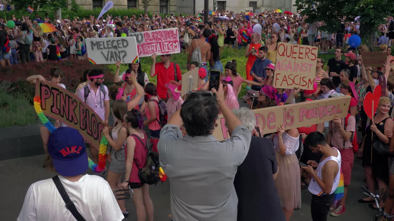 Colorful people getting ready to march in the Budapest Pride, Pink Blog and banners