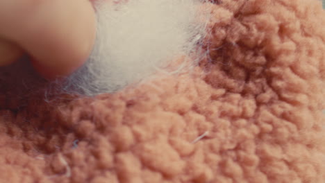 closeup of hand touching a soft, fuzzy fabric