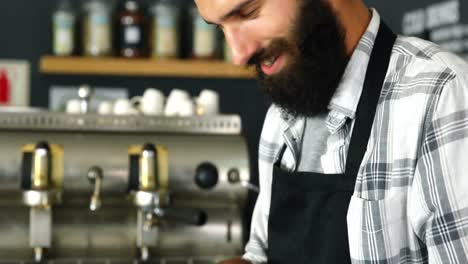 waiter using digital tablet at counter