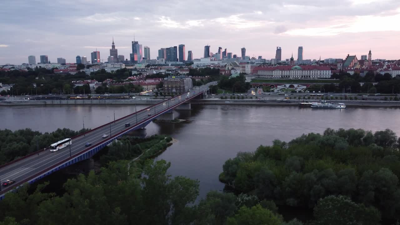 Cinematic drone footage of Warsaw skyline with vistula river and bridge filled with traffic