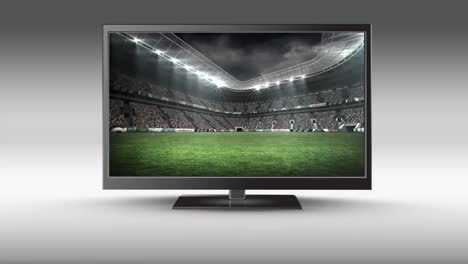 televisor de pantalla plana con un estadio de fútbol en su pantalla