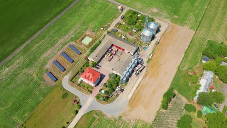 aerial view of farm, red barns, corn field in september