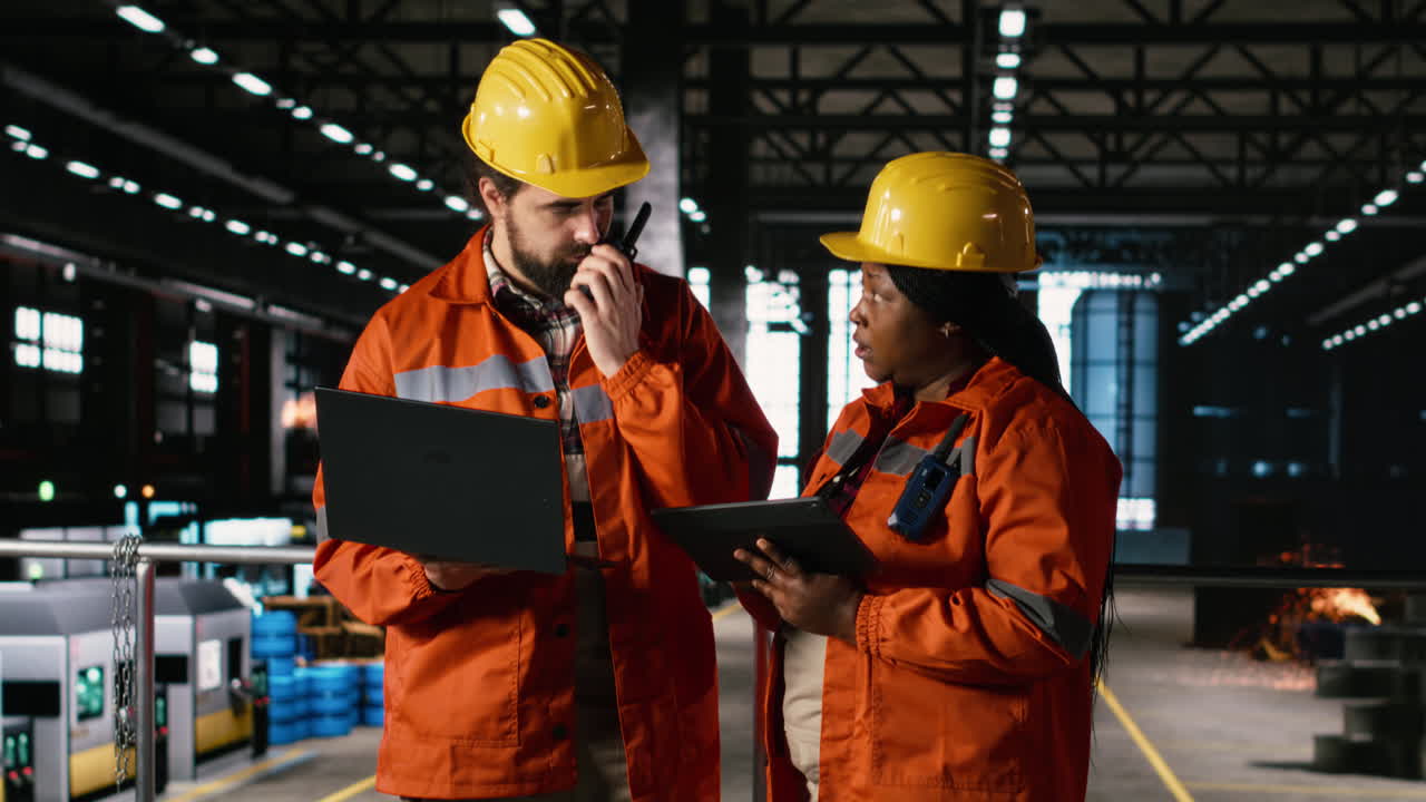 Diverse engineers supervising metalwork and welding operations