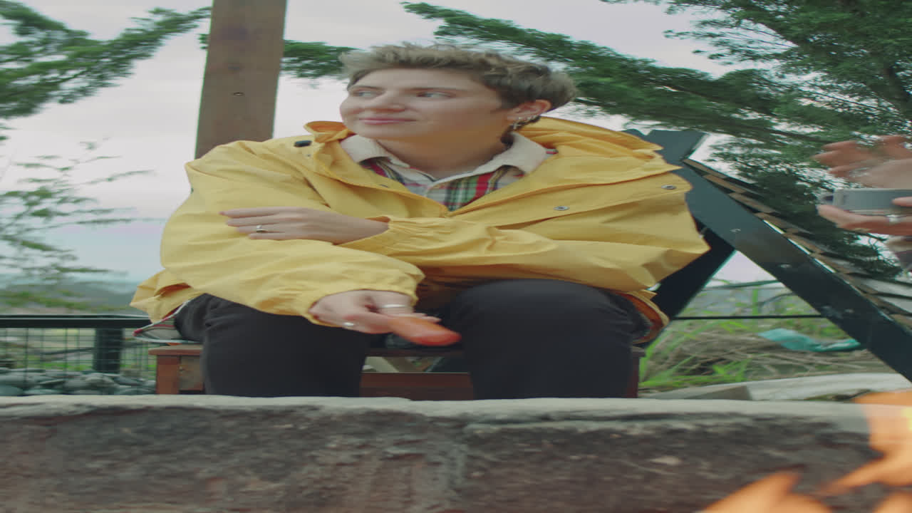 Female Tourist Cooking Sausage on Campfire and Talking with Friend