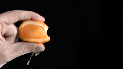 Orange-being-squeezed-in-super-slow-motion