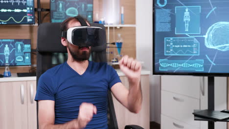 male scientist sitting on a chair and using virtual reality goggles