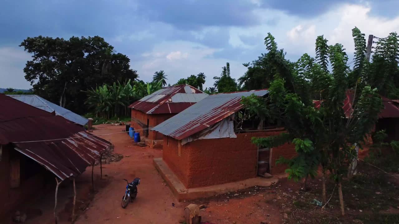 Aerial towards a rundown home in a small Nigerian quiet village. Local palmoil producing village in ibadan, Africa