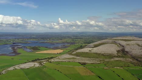 irish rural landscape, view from aughinish looking towards east burrin, clare, ireland, august 2020, drone gradually pushes towards burren hills